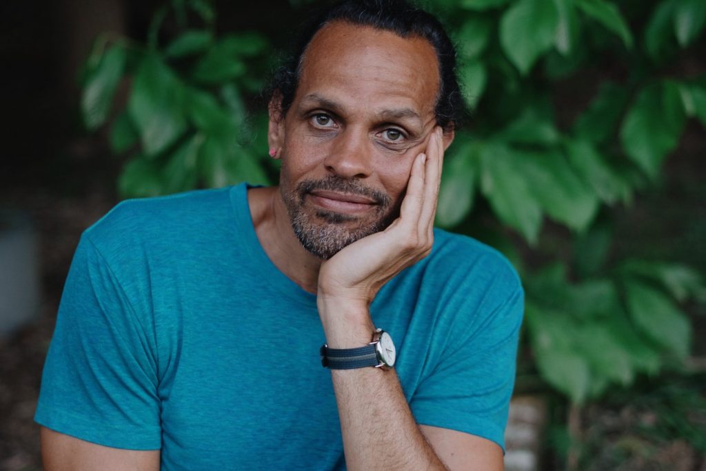 A bust photo of Ross Gay.